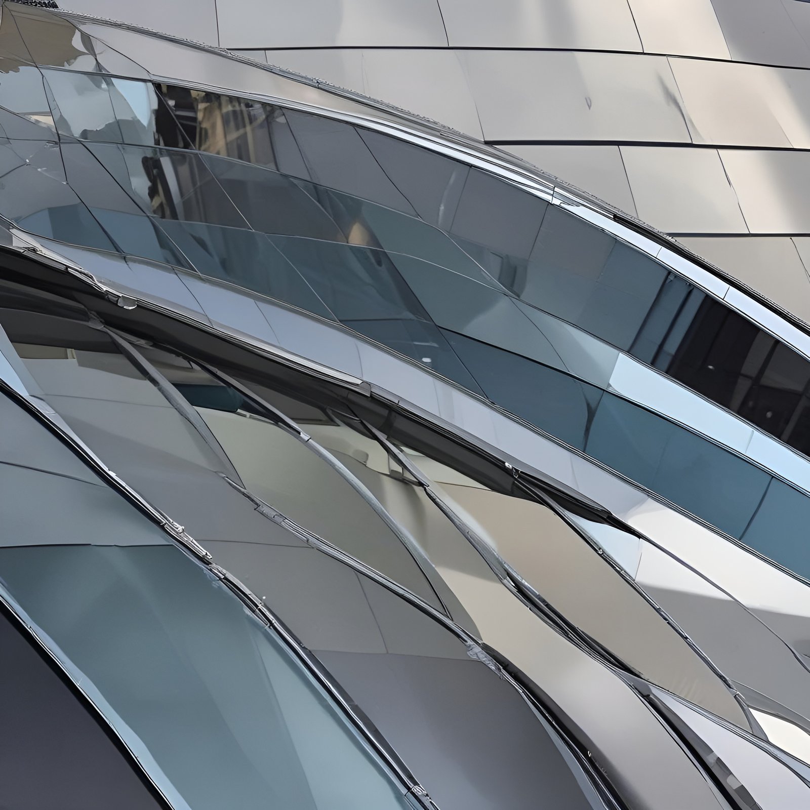 A creative photograph of curved glass and steel building panels with chrome seams catching sky and building reflections.